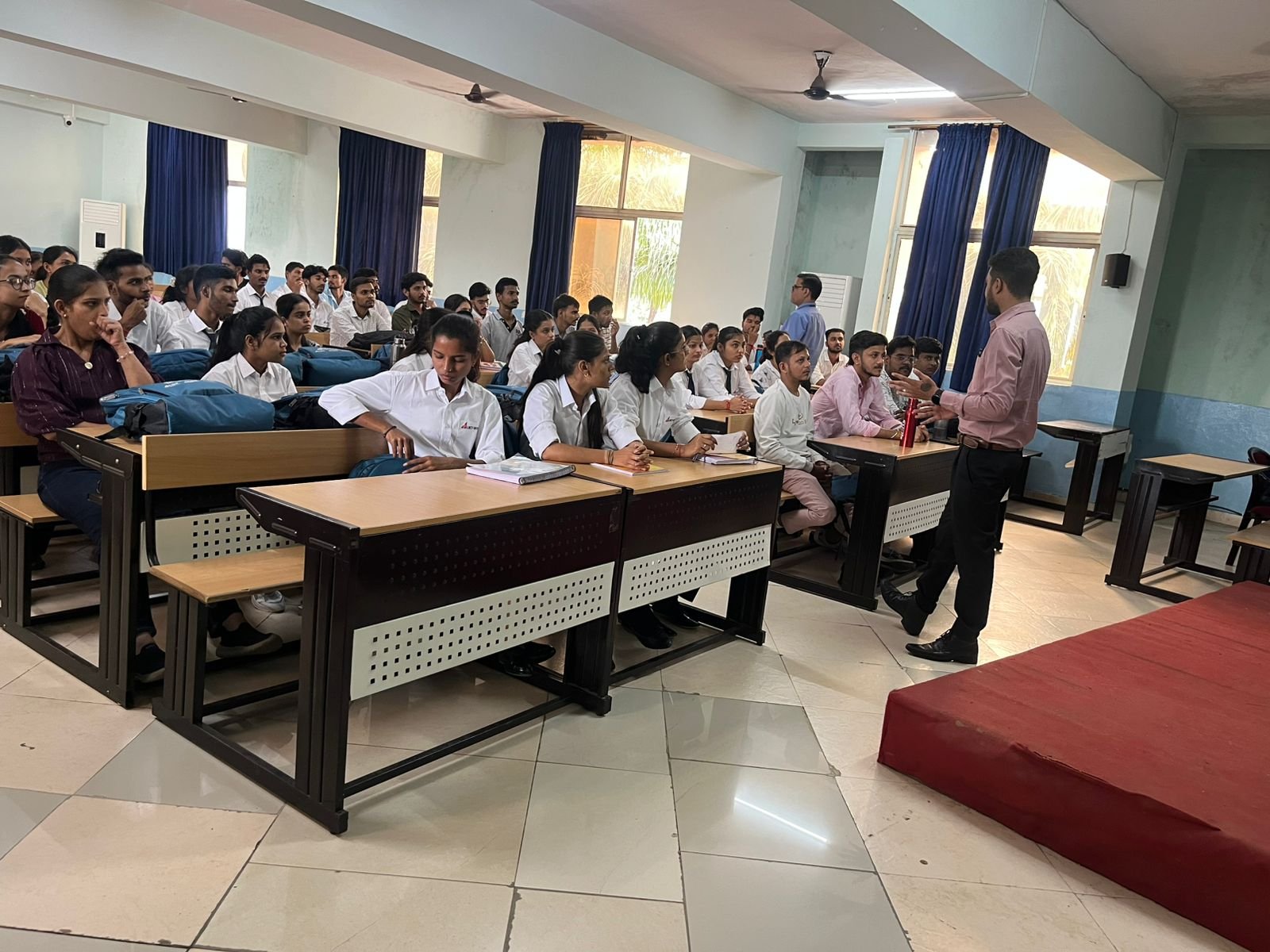 Students practicing CPR on mannequins during classroom session