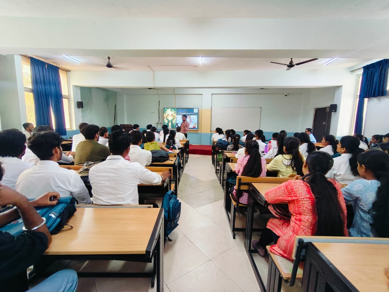 Students actively engaging in CPR session inside classroom